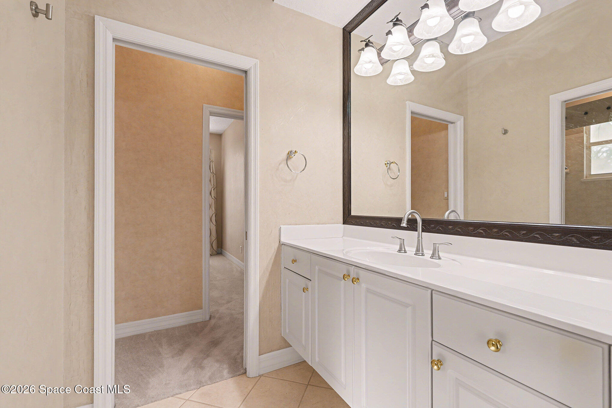 4325 Collingtree Drive Rockledge, FL 32955 - Photo 26 of 35 a bathroom with a sink and a mirror