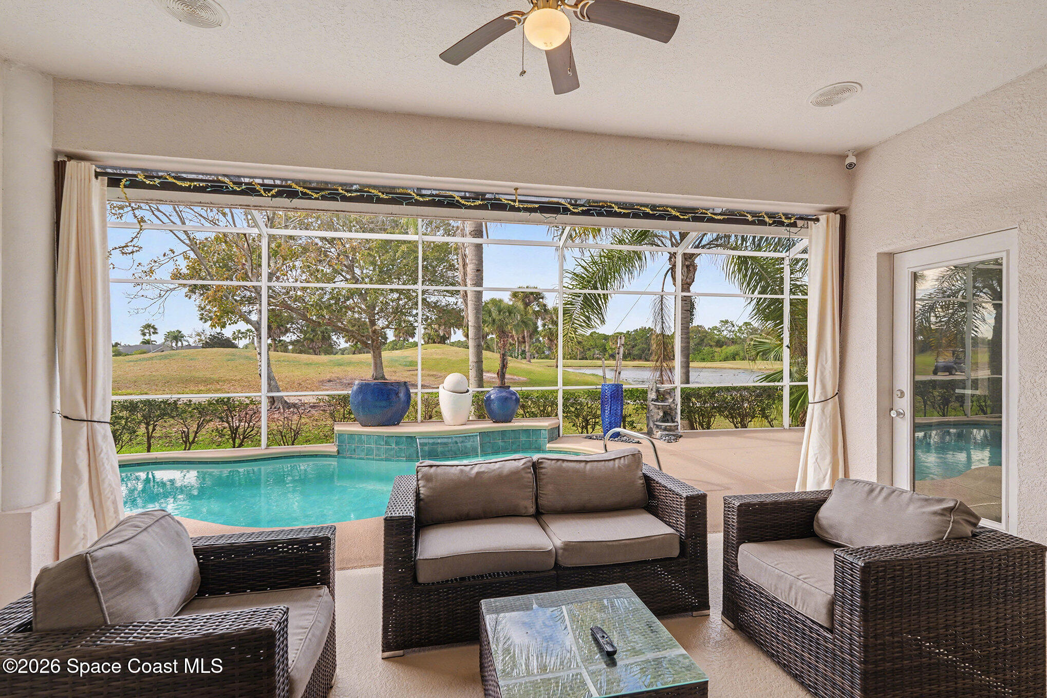 4325 Collingtree Drive Rockledge, FL 32955 - Photo 5 of 35 a living room with furniture and a floor to ceiling window