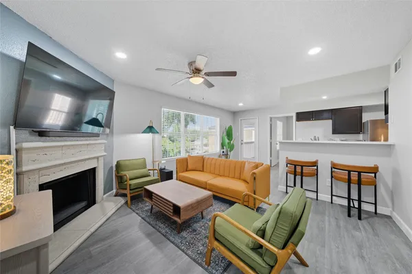 a living room with furniture and a fireplace