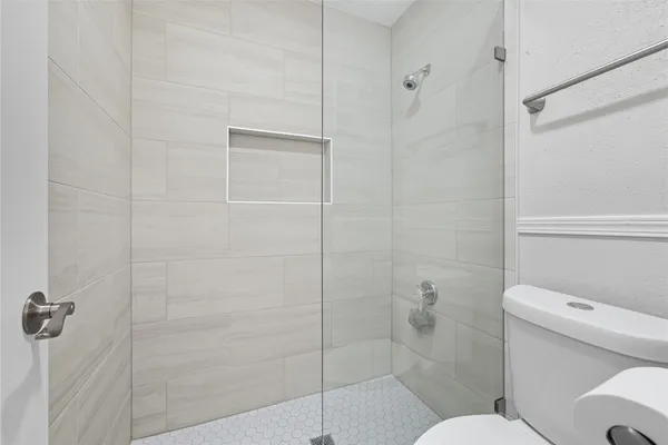 a bathroom with a toilet and a shower