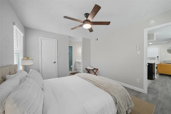 a bedroom with a bed and a ceiling fan