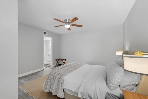 a bedroom with a bed and a ceiling fan