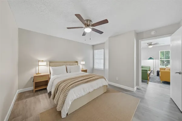 a bedroom with a bed and ceiling fan