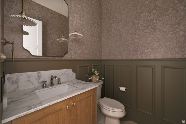 2281 South Crimson Cliffs Way St. George, UT 84790 - Photo 19 of 47 Bathroom featuring wallpapered walls, vanity, a wainscoted wall, and a decorative wall