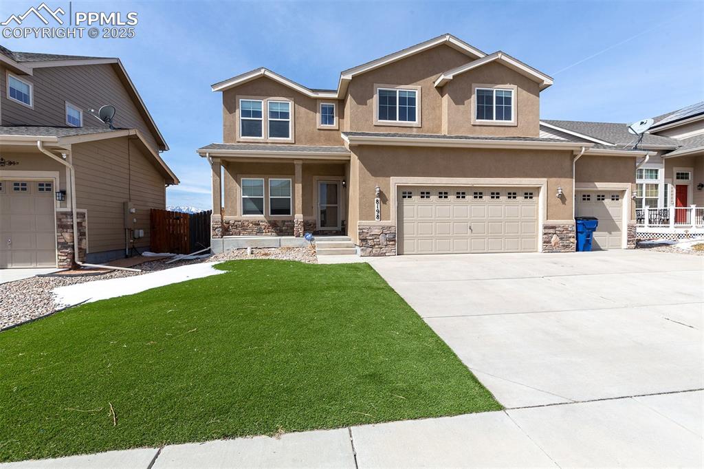 8198 Chasewood Loop Colorado Springs, CO 80908 - Photo 1 of 25 Craftsman-style home featuring a front lawn, stucco siding, an attached garage, and stone siding