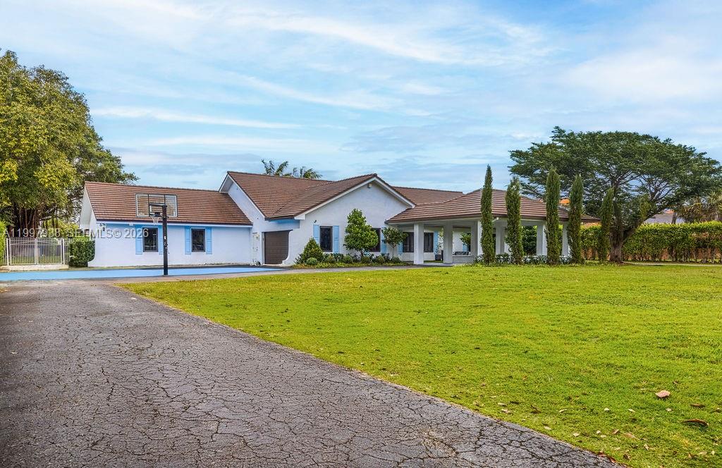 a front view of house with outdoor space and swimming pool