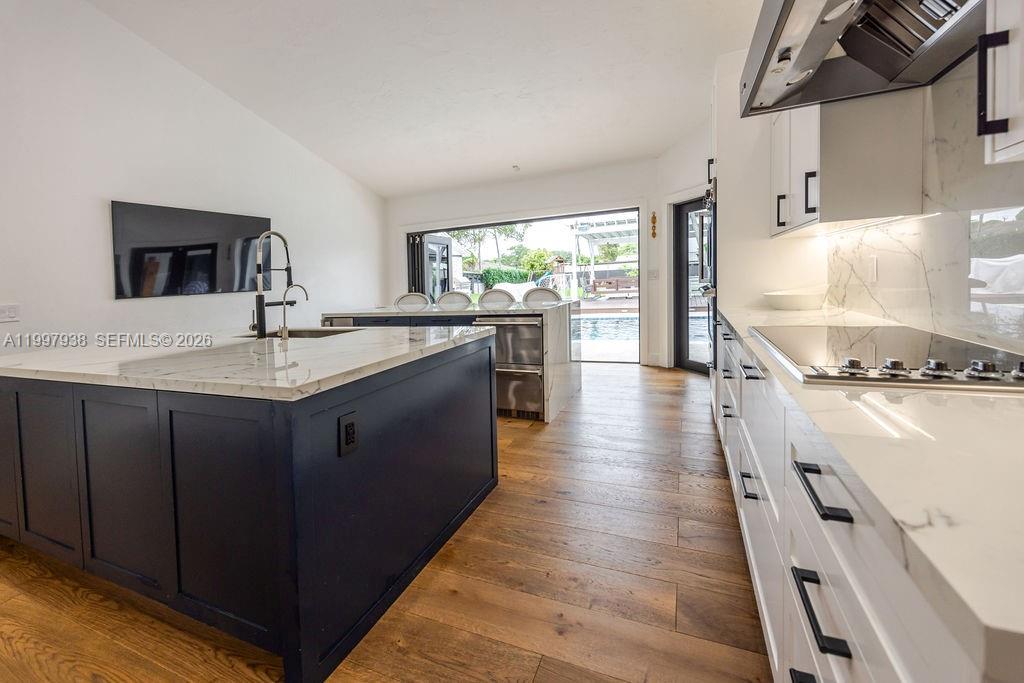 11301 Southwest 95th Street Miami, FL 33176 - Photo 14 of 56 a kitchen with stainless steel appliances granite countertop a sink stove and wooden floor
