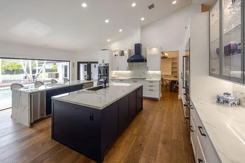 a large kitchen with a table and chairs in it
