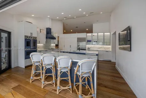a large kitchen with a large counter top appliances and cabinets