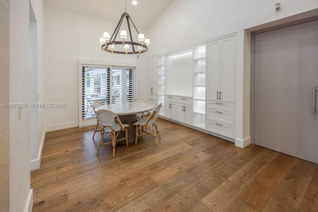 11301 Southwest 95th Street Miami, FL 33176 - Photo 22 of 56 an empty room with wooden floor a chandelier and windows