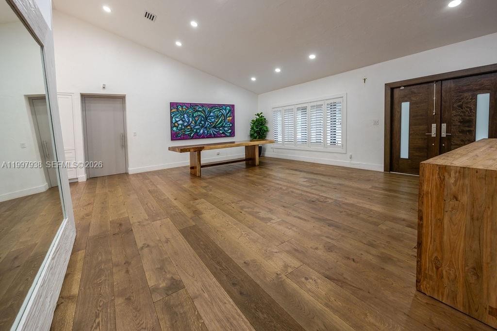 11301 Southwest 95th Street Miami, FL 33176 - Photo 26 of 56 a view of an empty room with wooden floor and a window