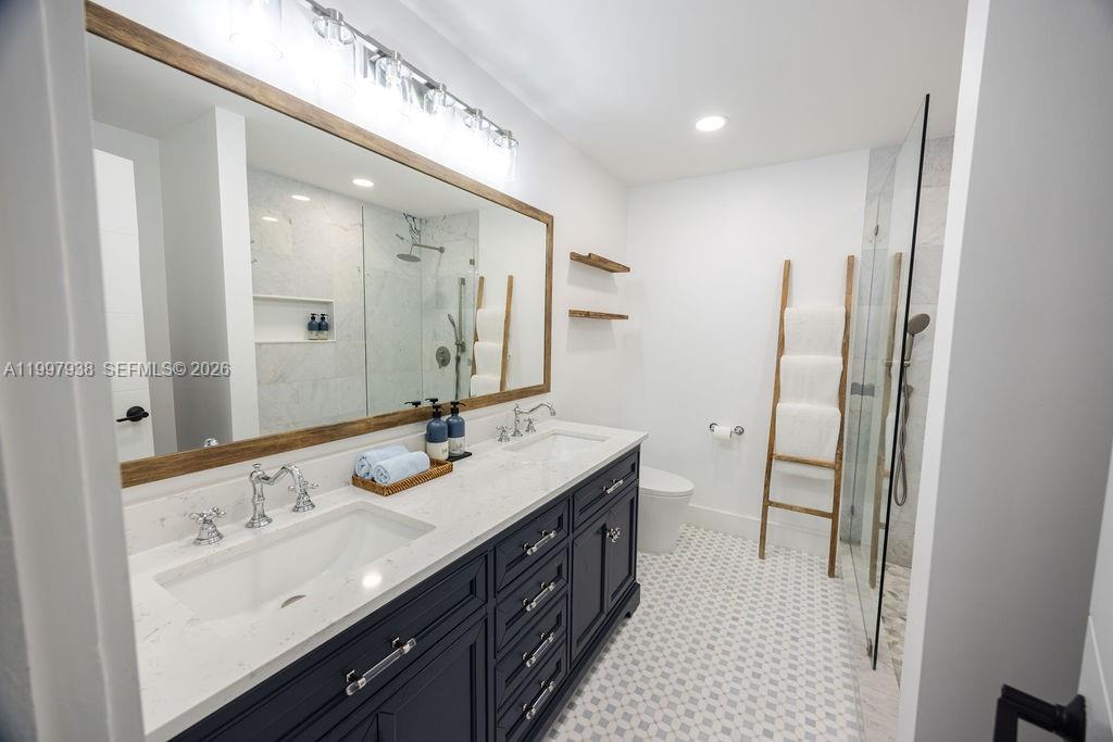 11301 Southwest 95th Street Miami, FL 33176 - Photo 28 of 56 a bathroom with a double vanity sink a and a mirror