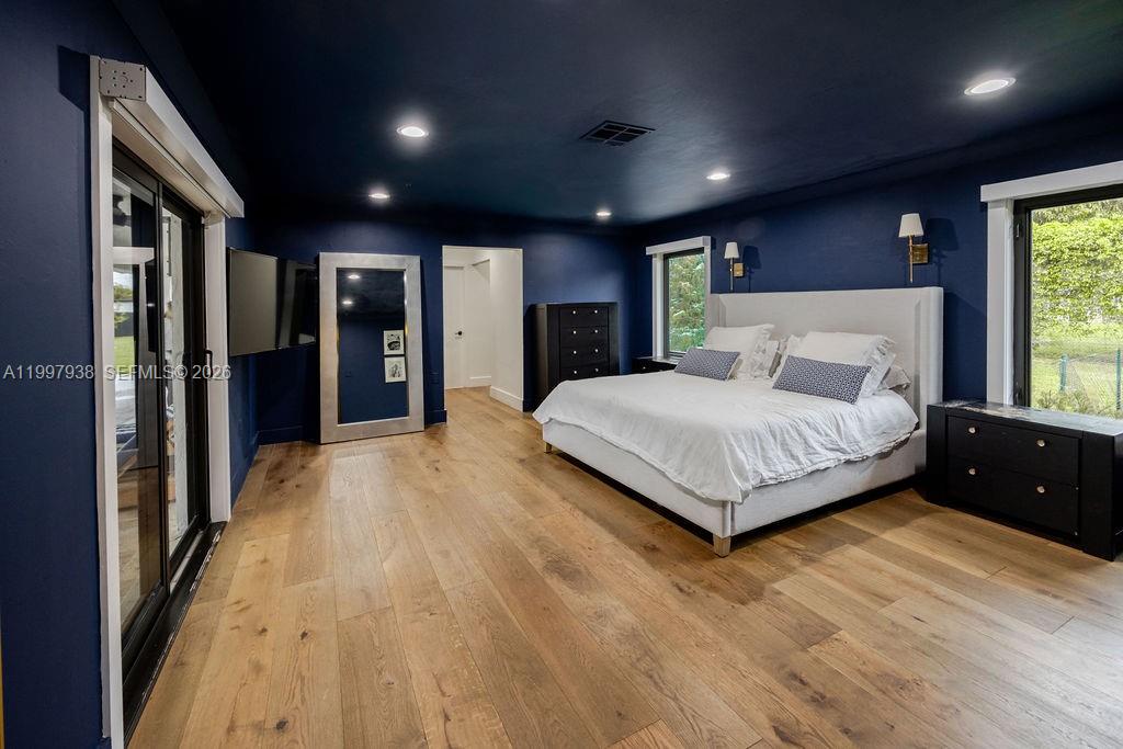 11301 Southwest 95th Street Miami, FL 33176 - Photo 35 of 56 a spacious bedroom with a large bed and a large window