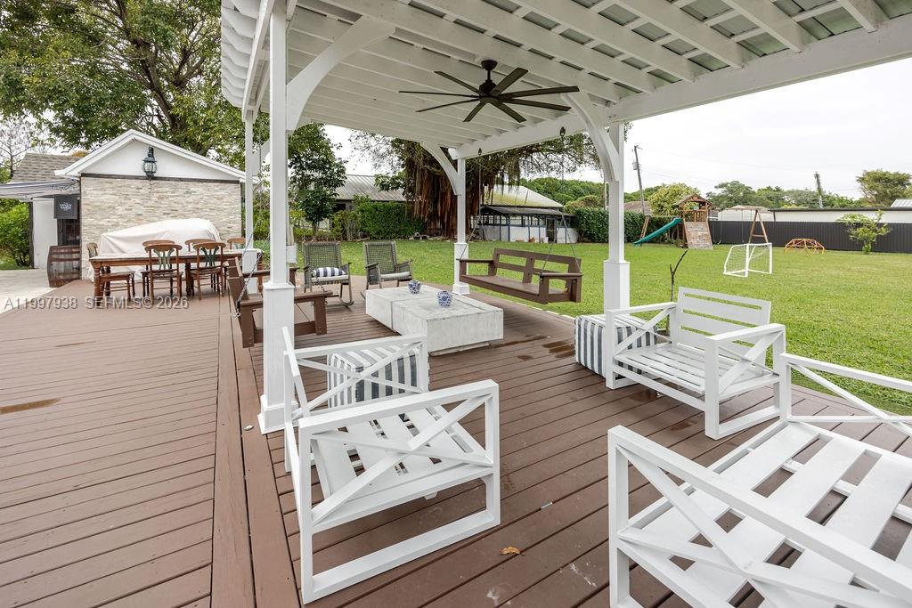 11301 Southwest 95th Street Miami, FL 33176 - Photo 41 of 56 a view of a patio with couches chairs and a big yard