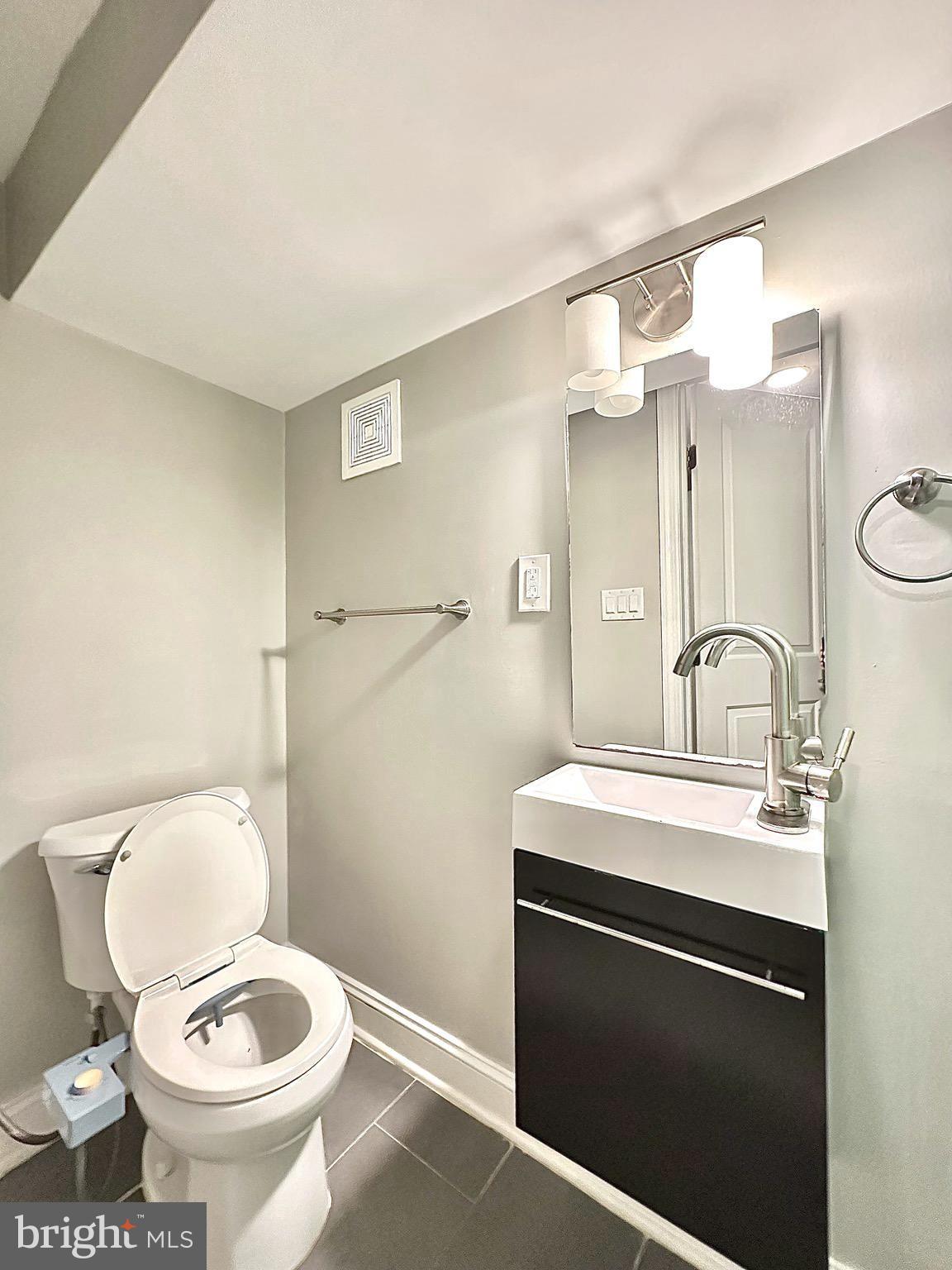 2514 West Seybert Street Philadelphia, PA 19121 - Photo 14 of 38 a bathroom with a toilet sink and mirror