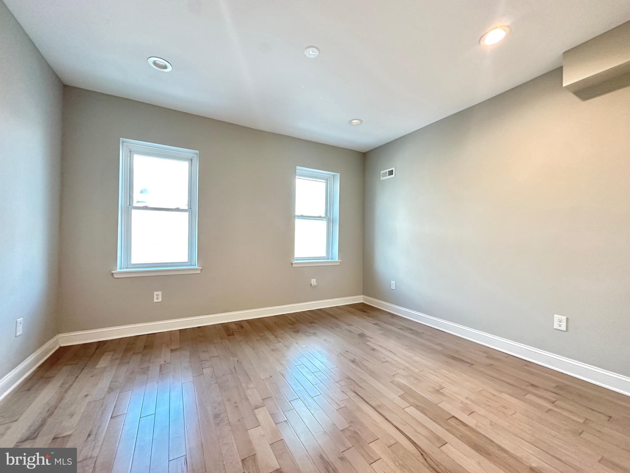 2514 West Seybert Street Philadelphia, PA 19121 - Photo 18 of 38 a view of an empty room with wooden floor and a window