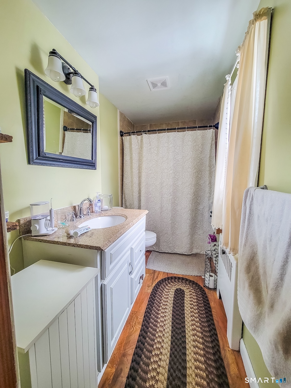 71 Cedar Lane Wallingford, CT 06492 - Photo 18 of 26 a bathroom with a granite countertop sink and a mirror