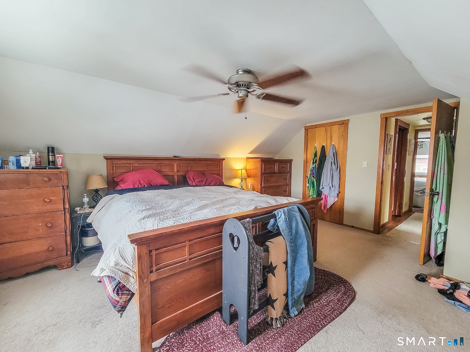 71 Cedar Lane Wallingford, CT 06492 - Photo 22 of 26 a bedroom with a bed and a chandelier