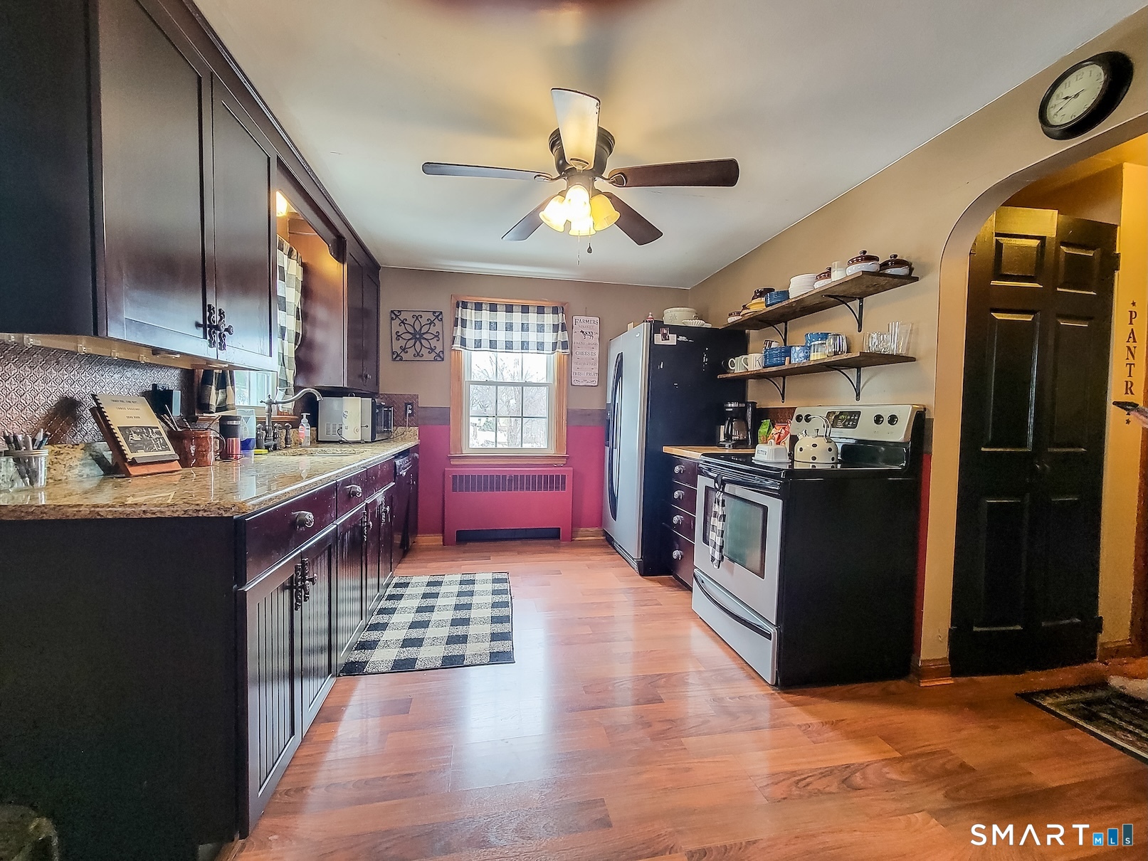71 Cedar Lane Wallingford, CT 06492 - Photo 3 of 26 a kitchen with stainless steel appliances granite countertop a refrigerator a sink dishwasher a stove and a dining table with wooden floor