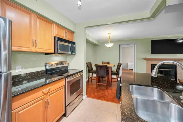 a kitchen with stainless steel appliances granite countertop a sink stove and microwave