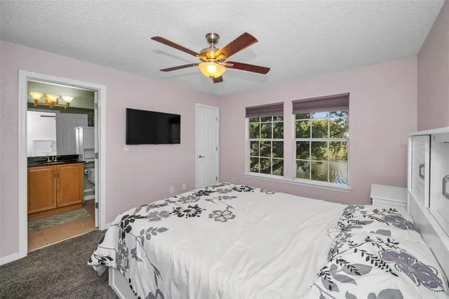 a bedroom with a bed and a television