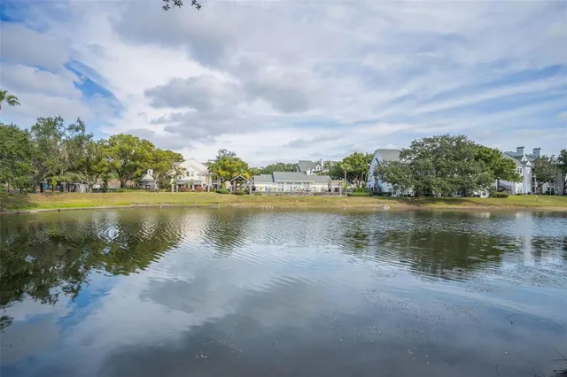 a view of a lake with houses in the back