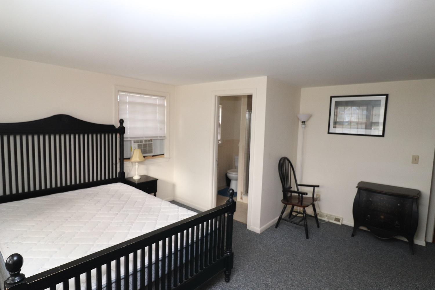 58 Sterling Road Hyannis, MA 02601 - Photo 9 of 19 a bedroom with a bed and a chair