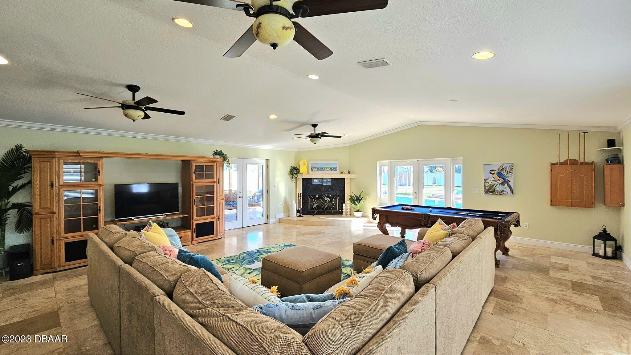 6 Sunrise Avenue Ormond Beach, FL 32176 - Photo 16 of 83 a living room with furniture and a flat screen tv