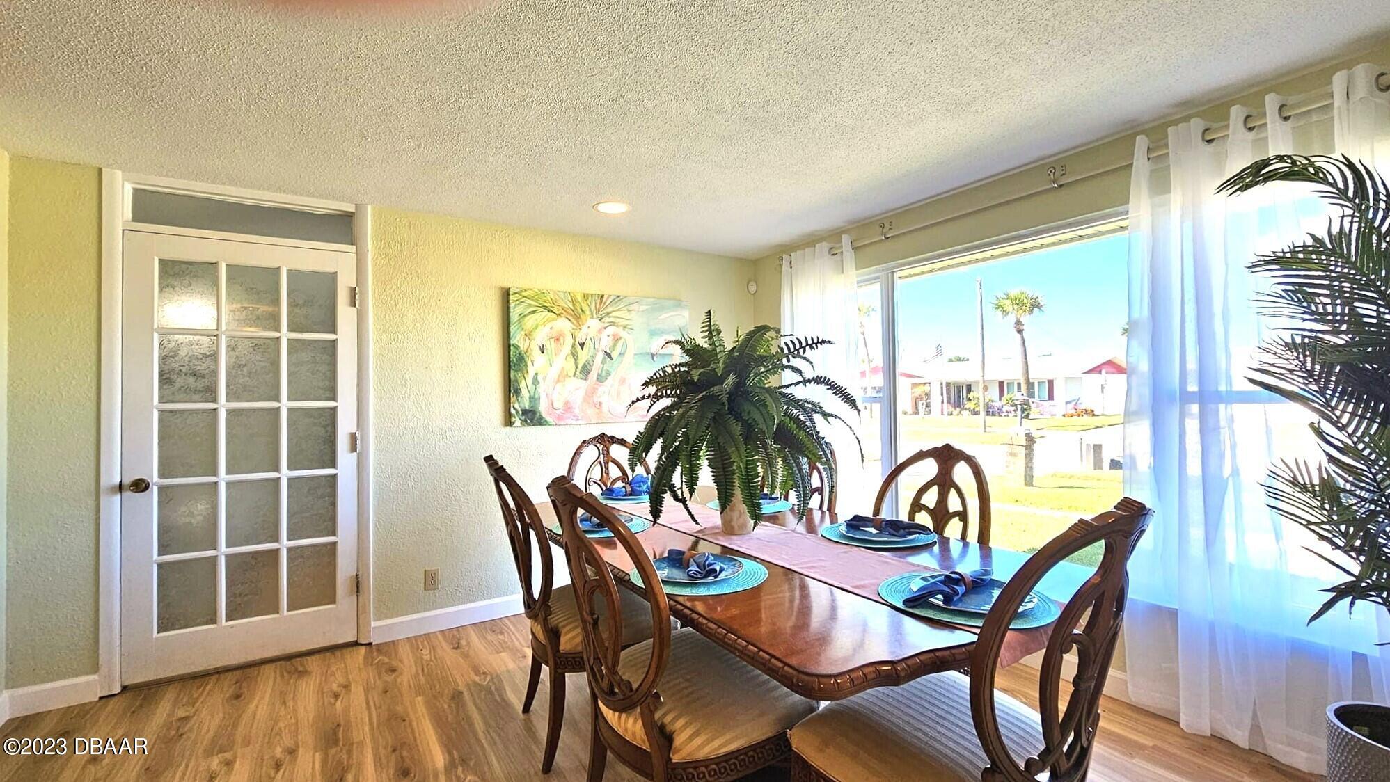 6 Sunrise Avenue Ormond Beach, FL 32176 - Photo 27 of 83 a view of a dining room with furniture and chandelier