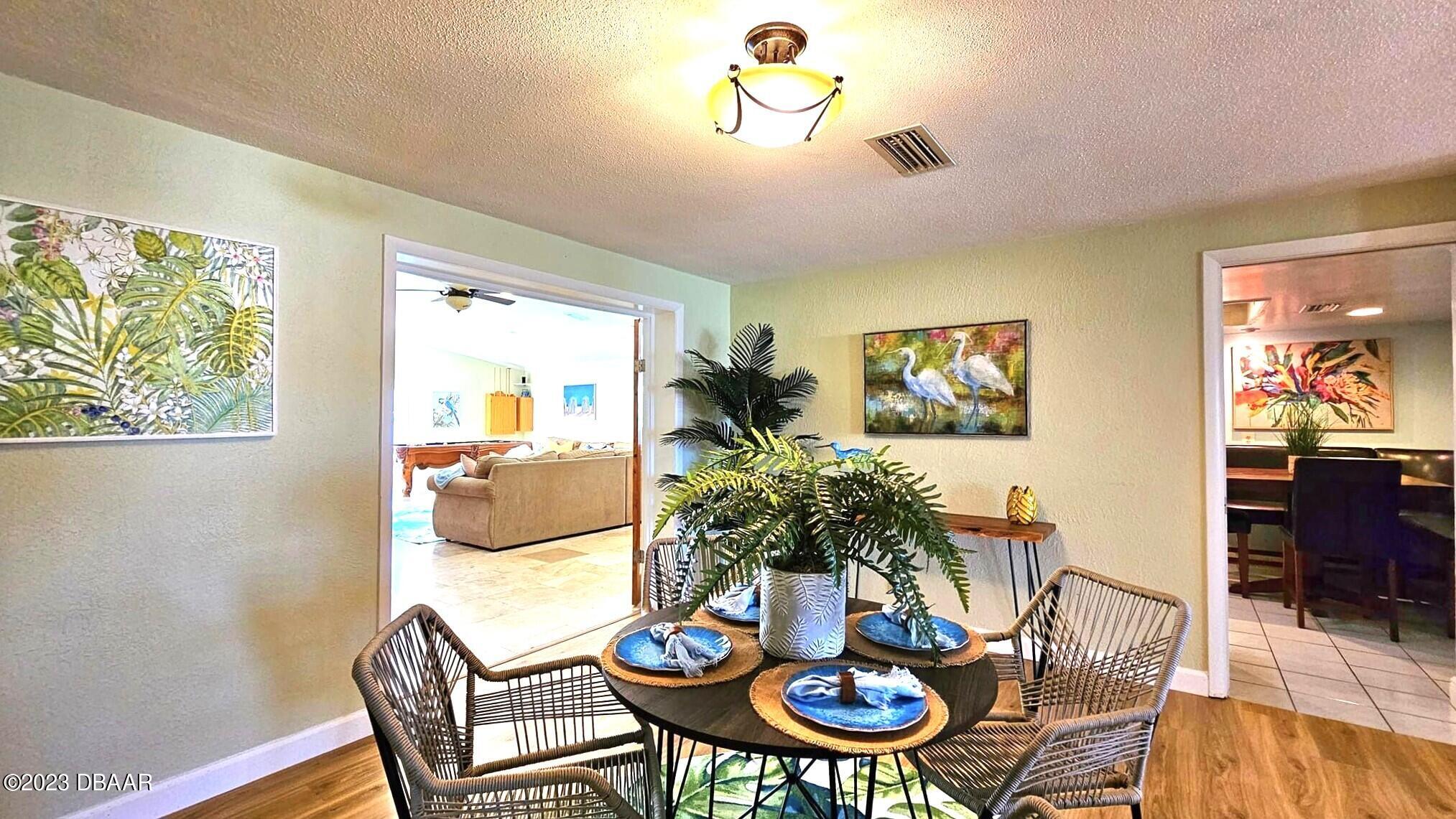 6 Sunrise Avenue Ormond Beach, FL 32176 - Photo 35 of 83 a view of a dining room with furniture a rug and wooden floor