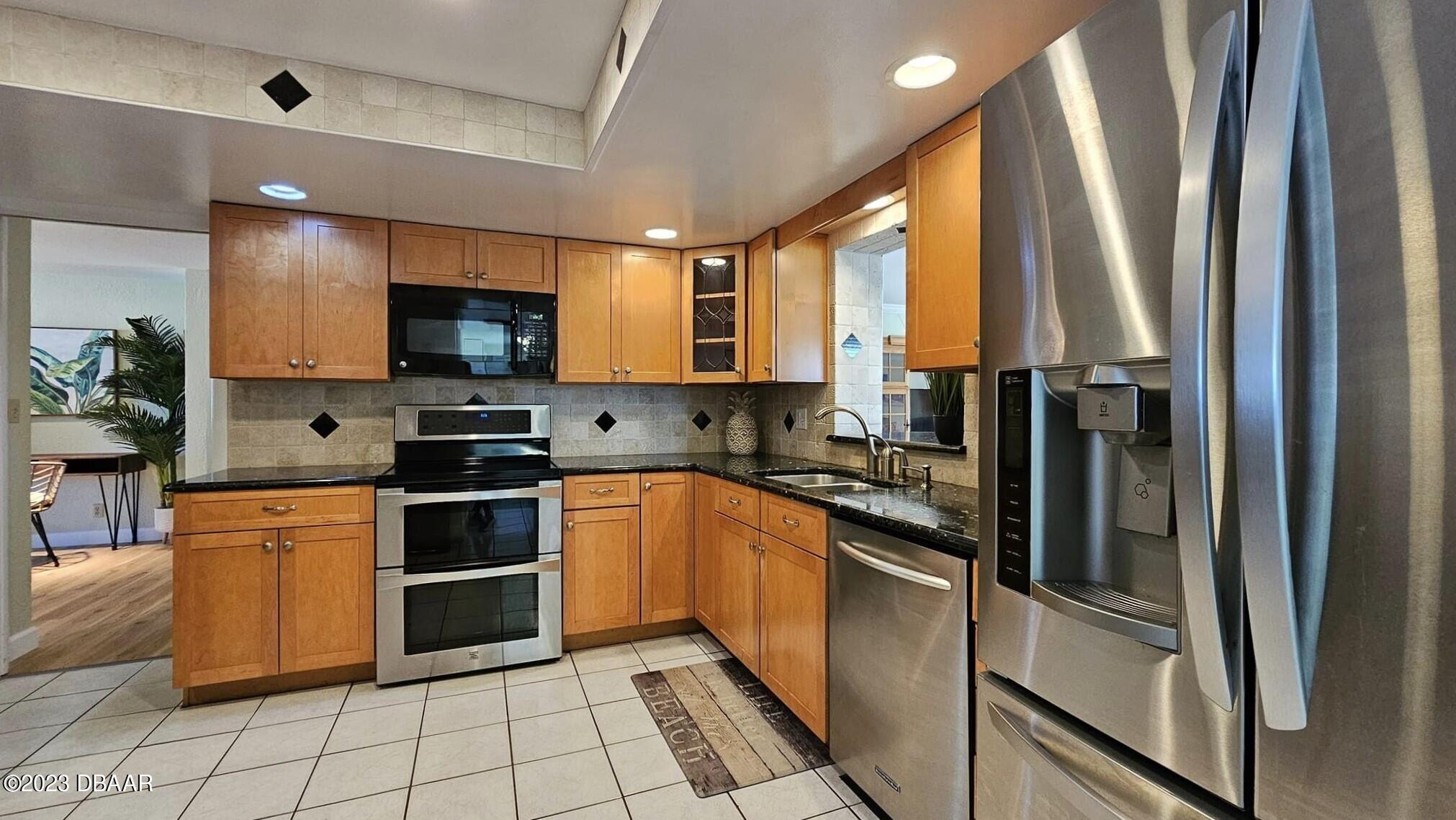 6 Sunrise Avenue Ormond Beach, FL 32176 - Photo 39 of 83 a kitchen with stainless steel appliances a refrigerator sink and microwave