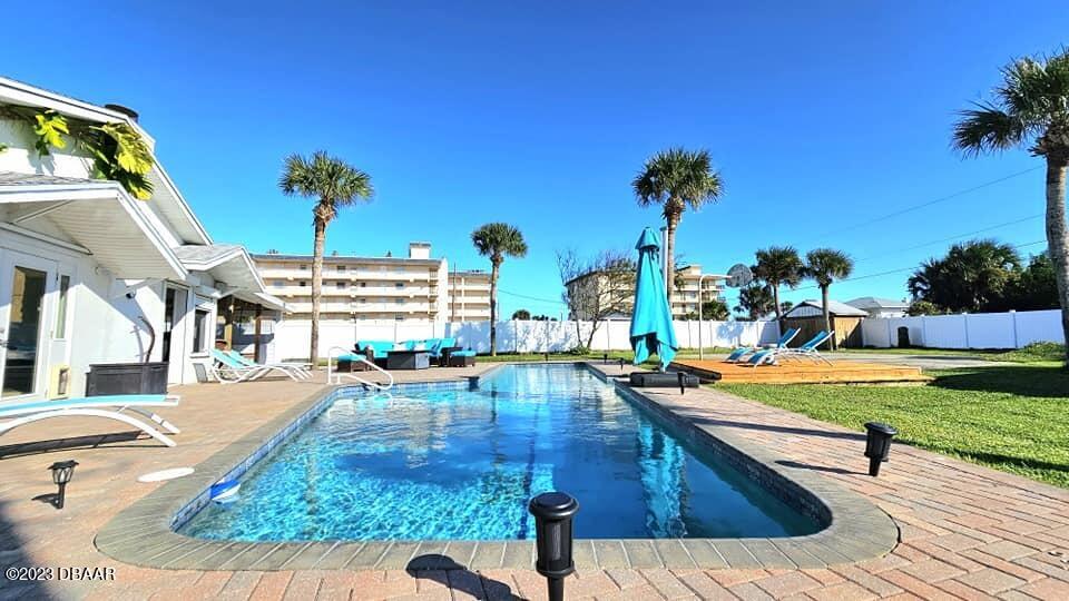 6 Sunrise Avenue Ormond Beach, FL 32176 - Photo 4 of 83 a view of a swimming pool with a lounge chairs