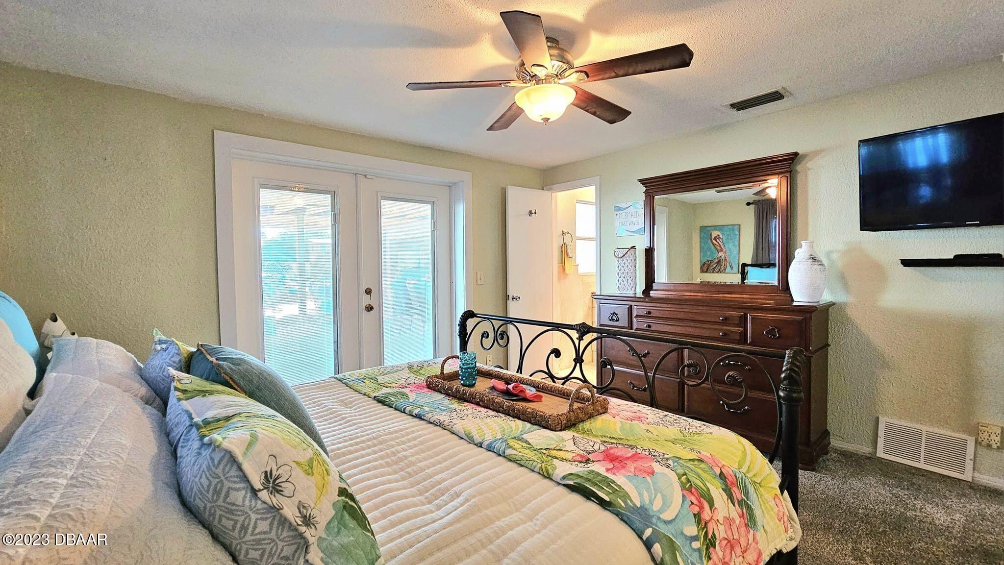 6 Sunrise Avenue Ormond Beach, FL 32176 - Photo 47 of 83 a bedroom with a bed and a flat screen tv
