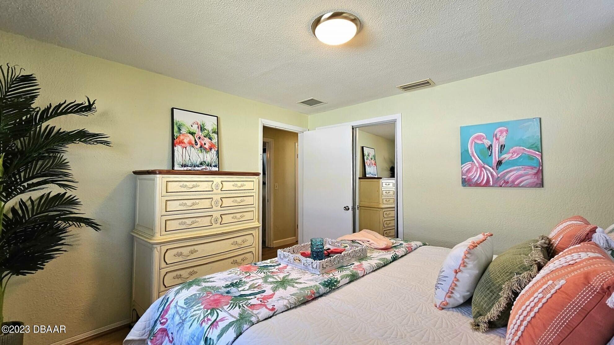 6 Sunrise Avenue Ormond Beach, FL 32176 - Photo 51 of 83 a bedroom with a bed and a painting on the wall