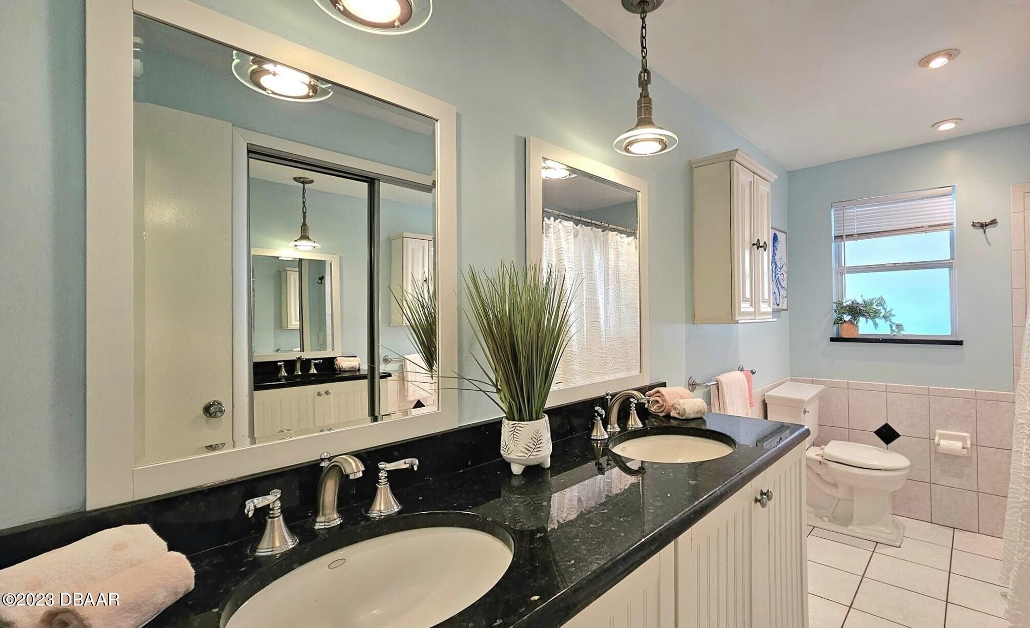 6 Sunrise Avenue Ormond Beach, FL 32176 - Photo 57 of 83 a bathroom with a granite countertop sink and a mirror