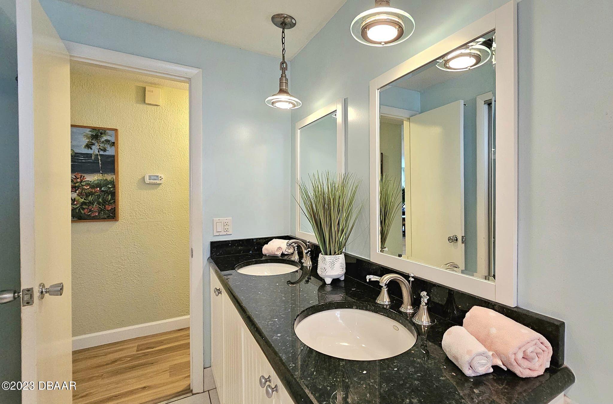 6 Sunrise Avenue Ormond Beach, FL 32176 - Photo 58 of 83 a bathroom with a granite countertop sink and a mirror