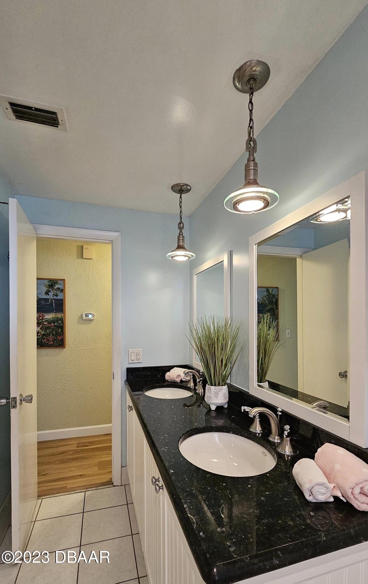 6 Sunrise Avenue Ormond Beach, FL 32176 - Photo 61 of 83 a bathroom with a granite countertop sink and a mirror