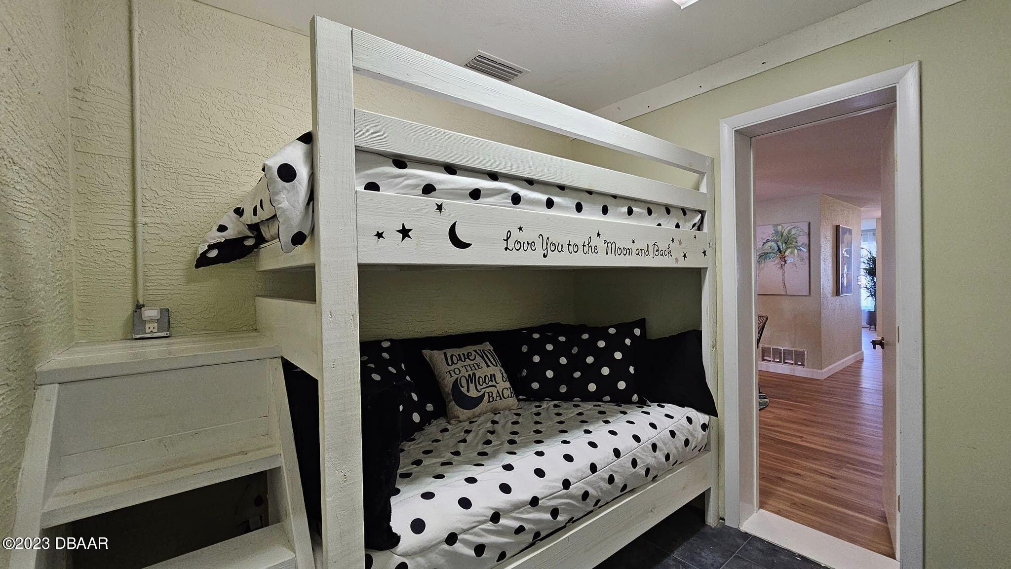 6 Sunrise Avenue Ormond Beach, FL 32176 - Photo 66 of 83 a bedroom with a bed and a baby dresser