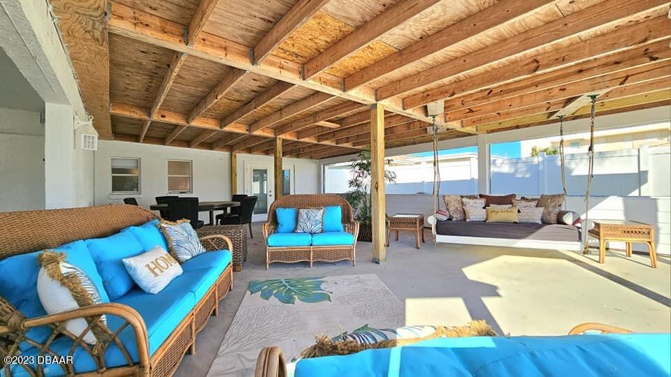 6 Sunrise Avenue Ormond Beach, FL 32176 - Photo 71 of 83 a living room with furniture and a chandelier