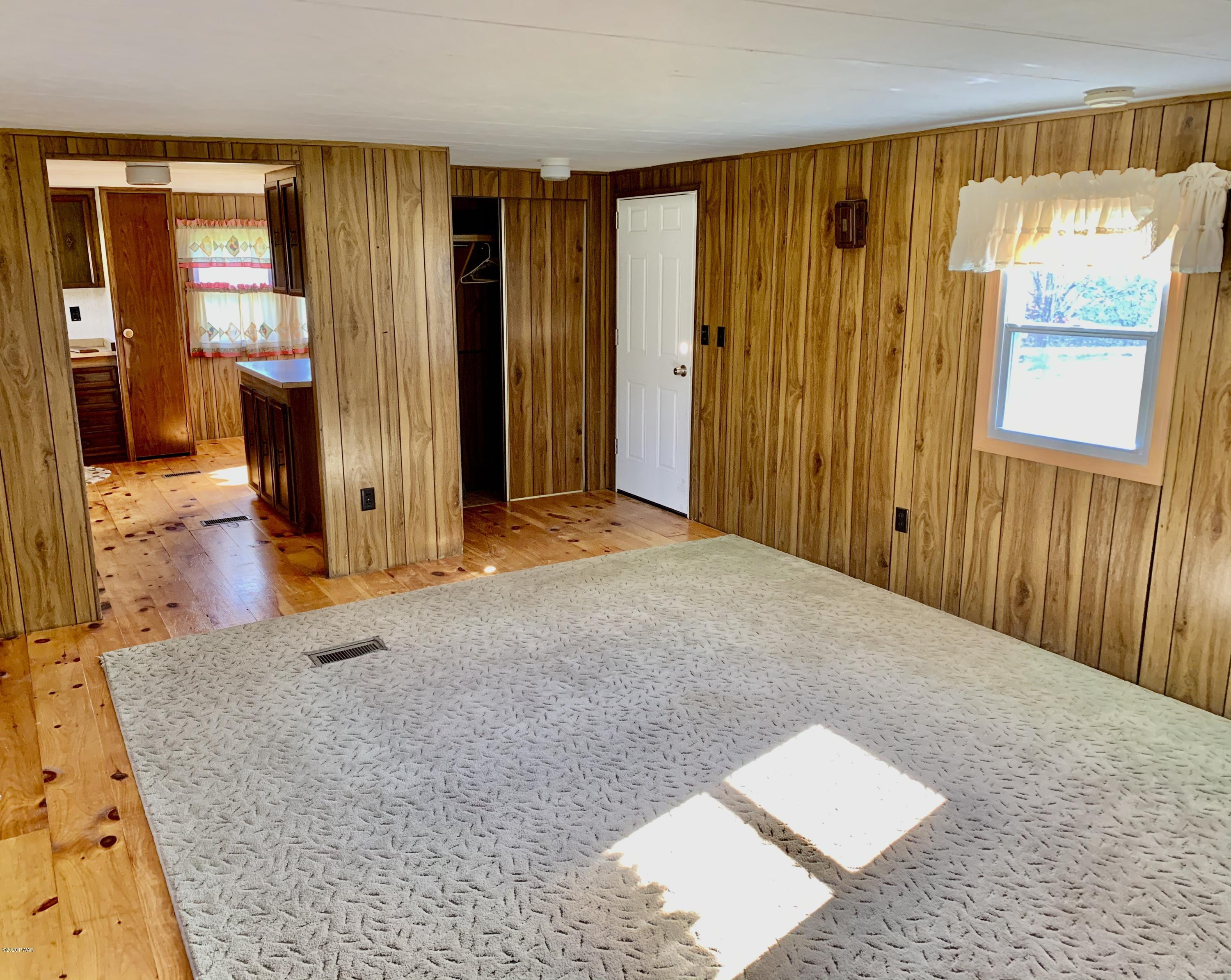 99 Slater Road Beach Lake, PA 18405 - Photo 15 of 35 a view of a bedroom with wooden floor and windows