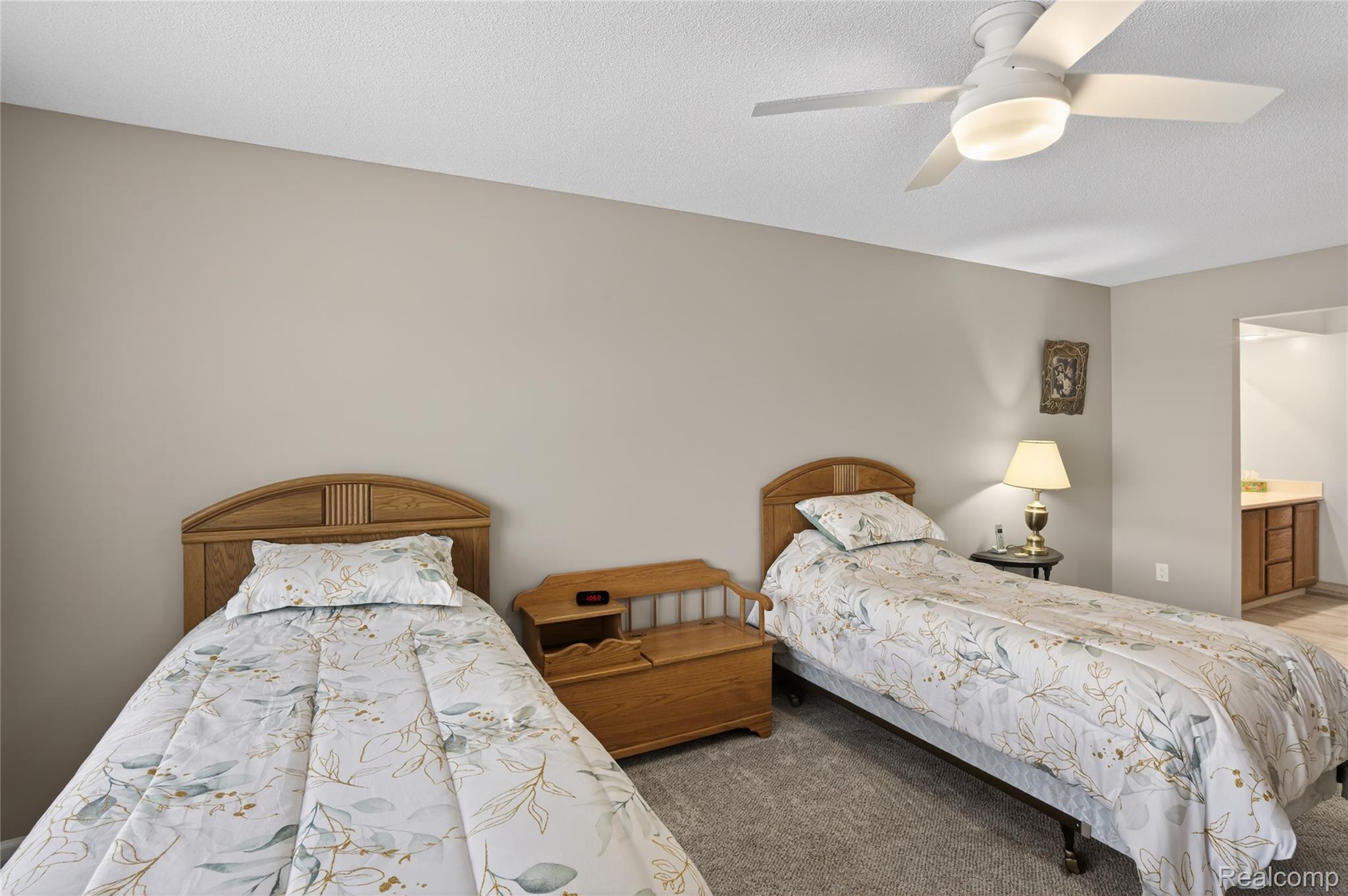 1715 River Road, Unit 77 St. Clair, MI 48079 - Photo 37 of 59 Bedroom with connected bathroom, carpet, and a ceiling fan