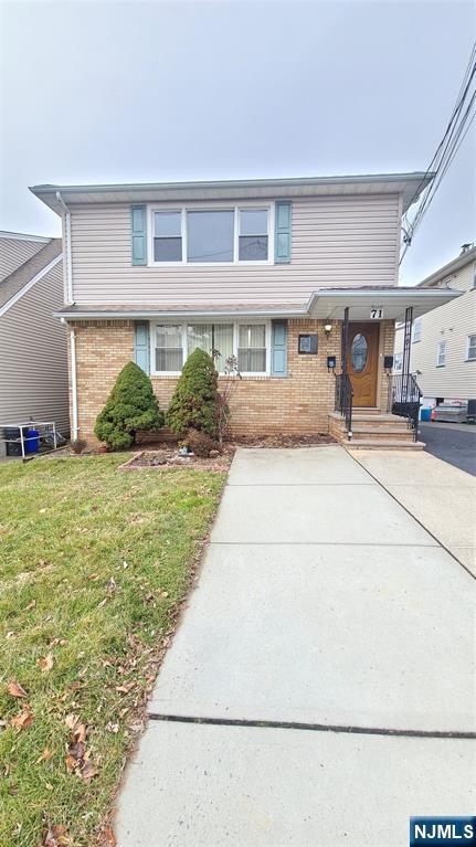 71 Newark Place, Unit 1 Belleville, NJ 07109 - Photo 1 of 6 a front view of building with yard
