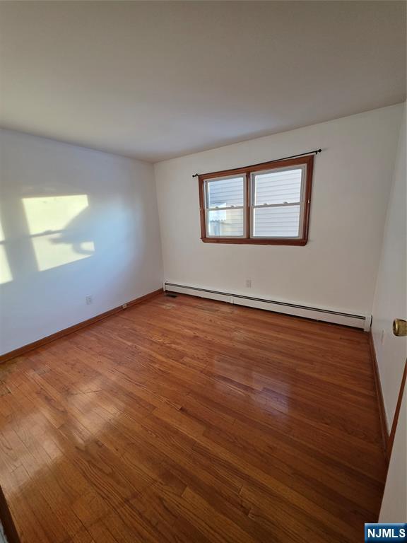 71 Newark Place, Unit 1 Belleville, NJ 07109 - Photo 2 of 6 an empty room with wooden floor and windows
