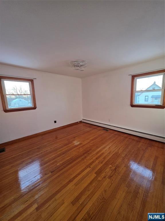 71 Newark Place, Unit 1 Belleville, NJ 07109 - Photo 3 of 6 a view of empty room with wooden floor and fan