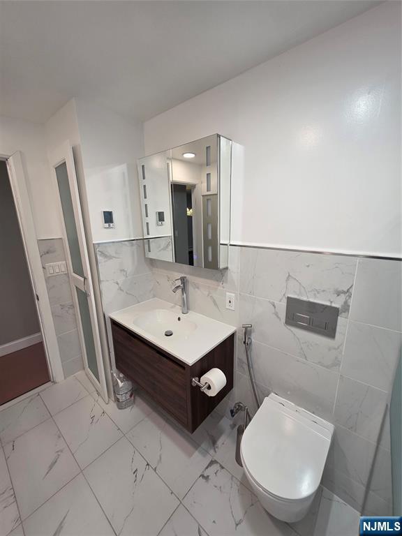 71 Newark Place, Unit 1 Belleville, NJ 07109 - Photo 6 of 6 a bathroom with a toilet a sink and a mirror