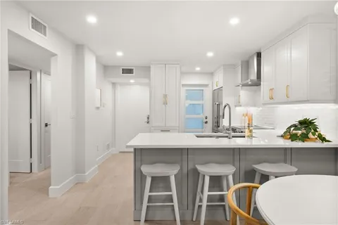 a kitchen with kitchen island cabinets and chairs in it