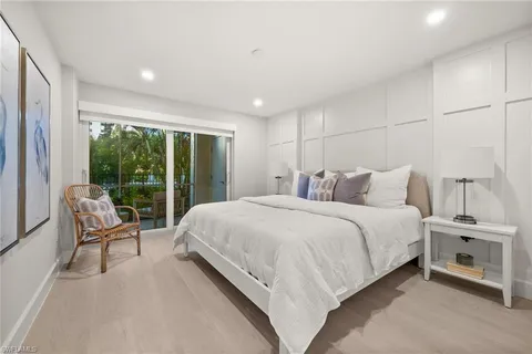 a bedroom with a bed and a view of balcony