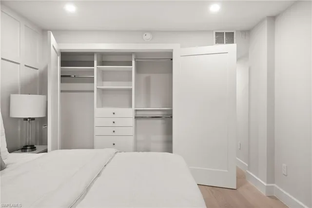 a view of a bedroom with closet and cabinet