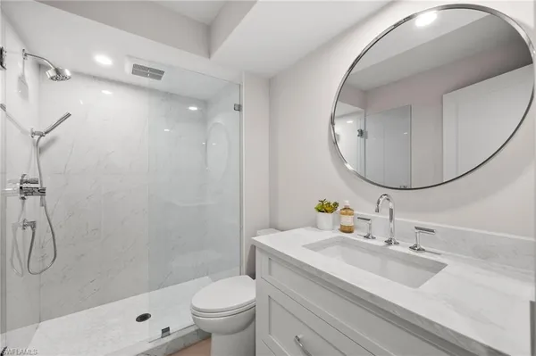 a bathroom with a sink toilet and shower