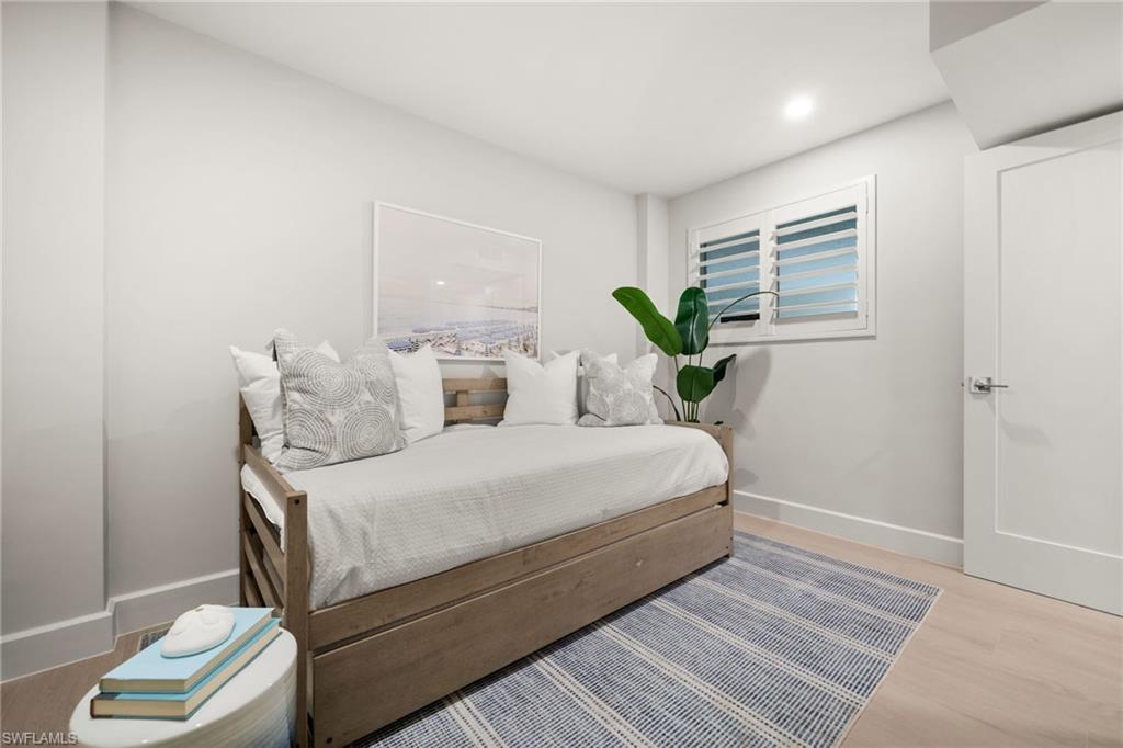 1300 Gulf Shore Boulevard North, Unit 109 Naples, FL 34102 - Photo 25 of 42 Serene bedrooms with custom closet systems and plantation shutters for a polished touch.